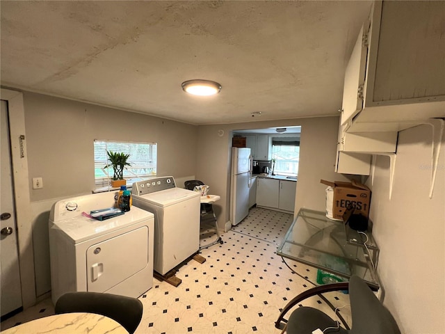 washroom with independent washer and dryer