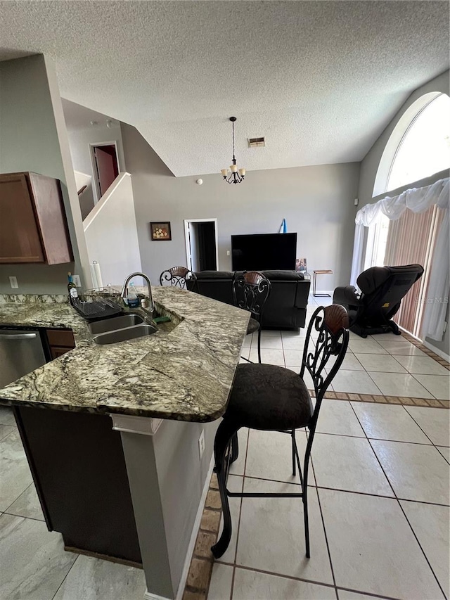 kitchen featuring light tile patterned floors, a textured ceiling, and sink