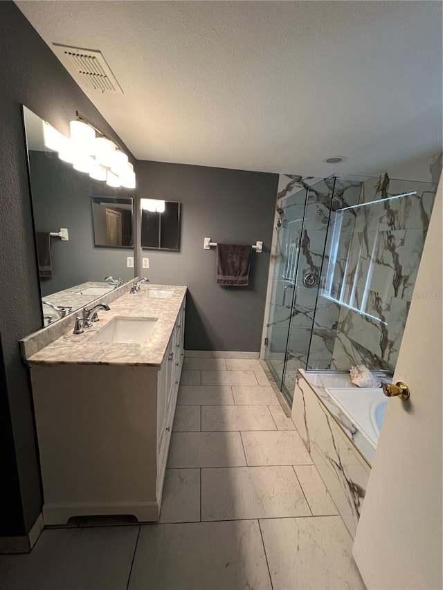 bathroom featuring vanity, independent shower and bath, and a textured ceiling