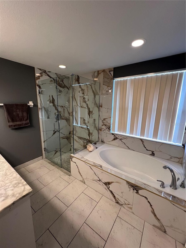 bathroom featuring separate shower and tub and vanity