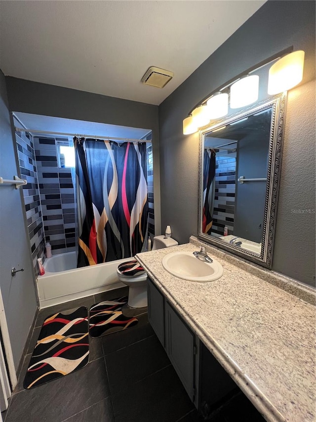 full bathroom with tile patterned floors, shower / bath combination with curtain, toilet, and vanity