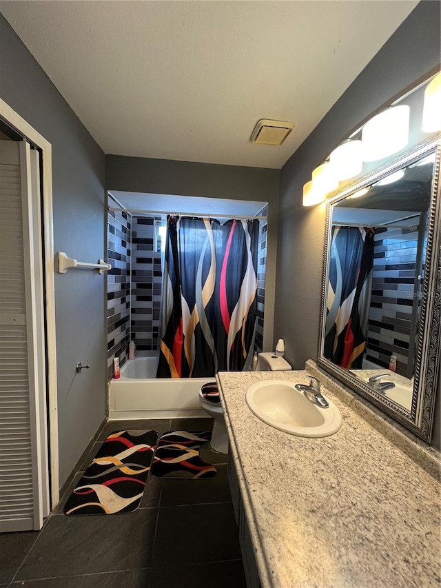 full bathroom with tile patterned flooring, vanity, shower / tub combo, and toilet