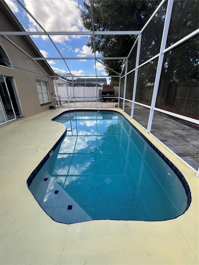 view of pool featuring a lanai and a patio