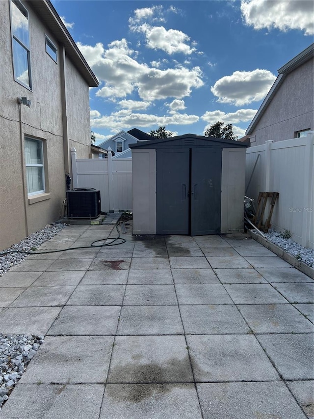 view of patio / terrace with a shed and cooling unit