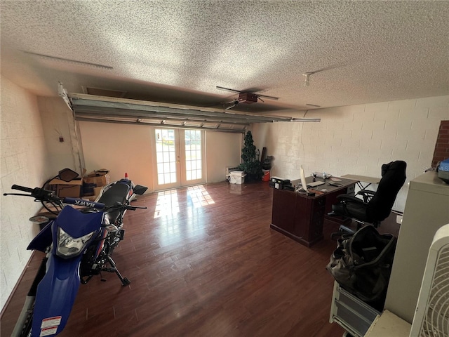 home office featuring a textured ceiling, french doors, and dark hardwood / wood-style floors