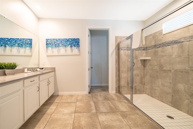 bathroom with tile patterned floors, vanity, and a tile shower