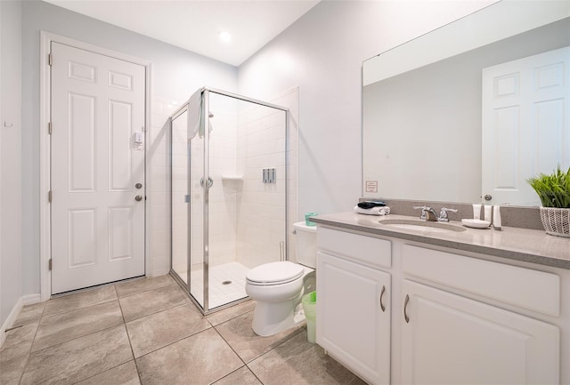 bathroom with walk in shower, vanity, toilet, and tile patterned flooring