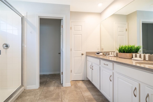 bathroom with vanity and a shower with shower door