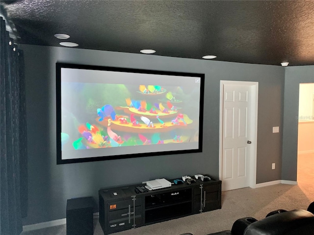 home theater room with carpet and a textured ceiling