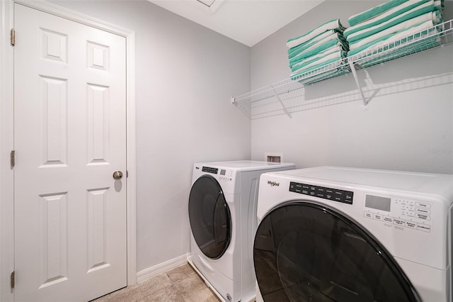 washroom featuring washer and clothes dryer