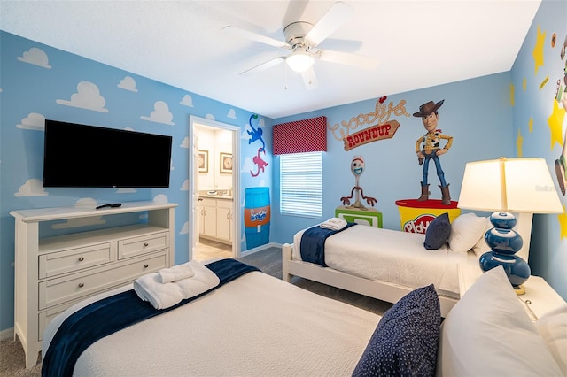 carpeted bedroom with ceiling fan and ensuite bath