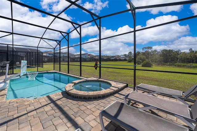 view of swimming pool with an in ground hot tub, a yard, glass enclosure, and a patio area