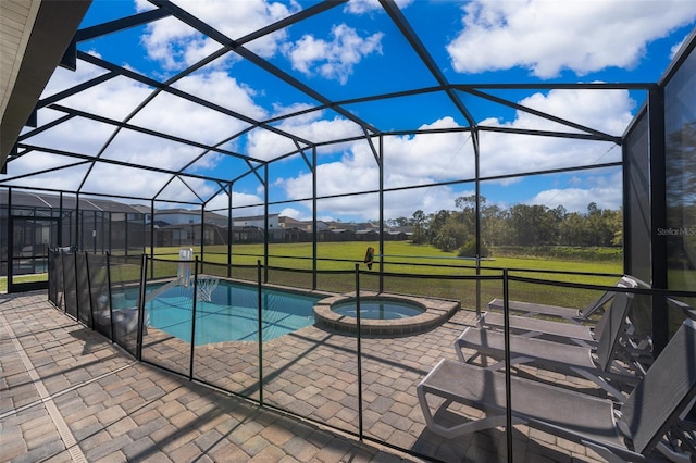 view of swimming pool featuring an in ground hot tub, a patio, glass enclosure, and a lawn