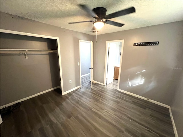 unfurnished bedroom featuring dark hardwood / wood-style floors, ceiling fan, a textured ceiling, and a closet