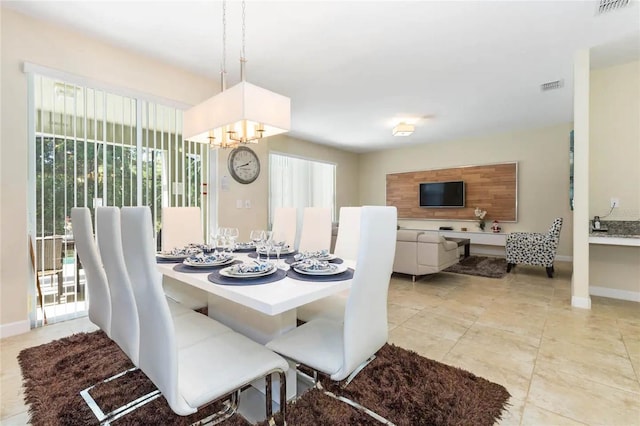 tiled dining space with an inviting chandelier