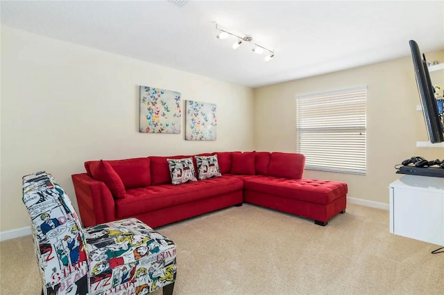 carpeted living room with track lighting