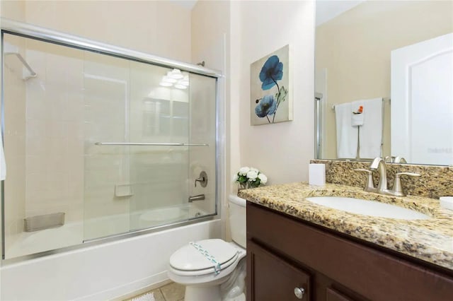 full bathroom featuring tile patterned flooring, vanity, enclosed tub / shower combo, and toilet