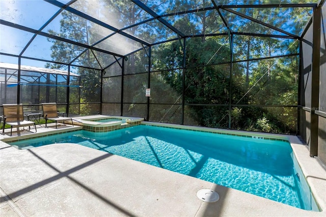 view of swimming pool with glass enclosure, an in ground hot tub, and a patio