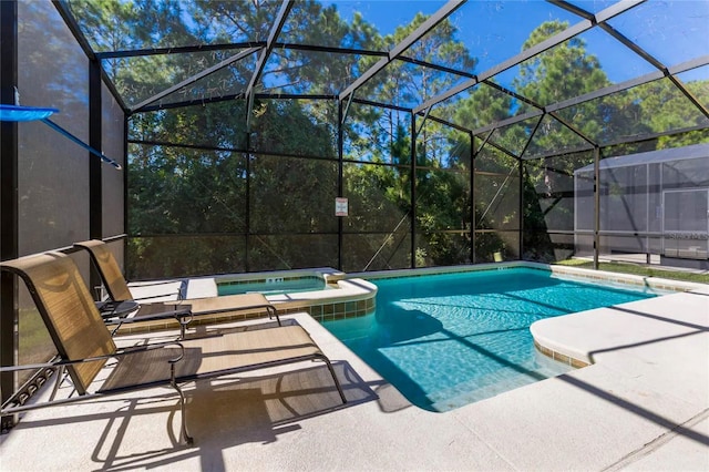 view of pool featuring a lanai, a patio area, and an in ground hot tub