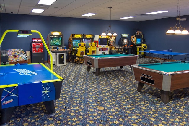 game room featuring a paneled ceiling and dark colored carpet