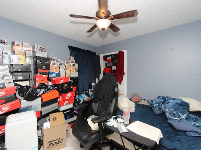 bedroom featuring a textured ceiling and ceiling fan