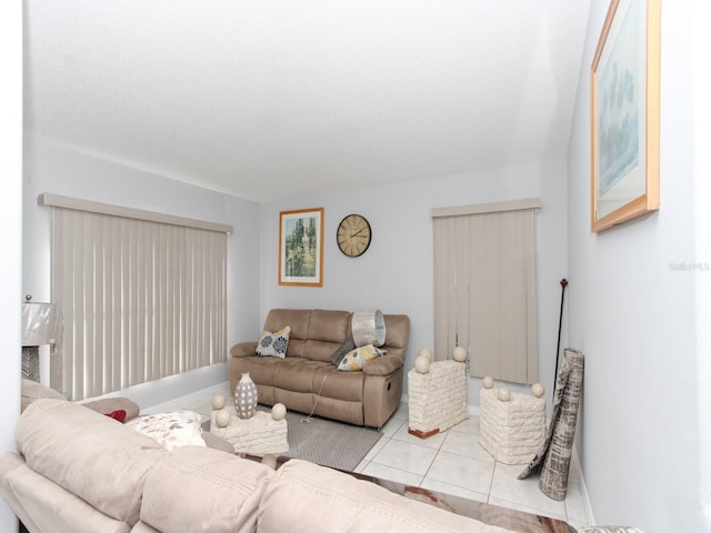 tiled living room featuring a textured ceiling