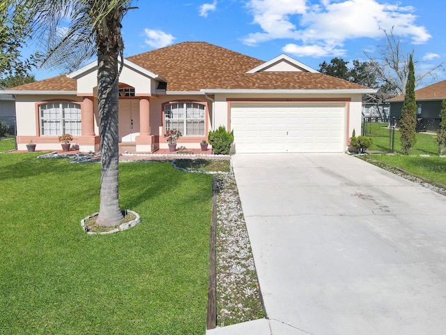 ranch-style house featuring a front yard and a garage