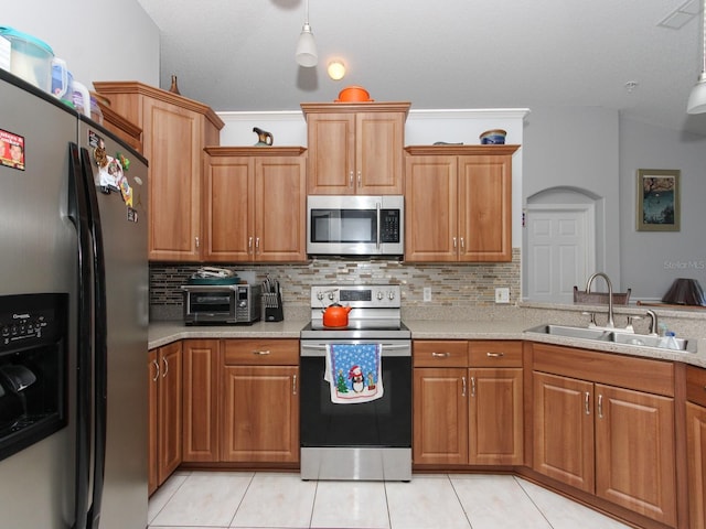 kitchen featuring decorative backsplash, sink, light tile patterned floors, and stainless steel appliances