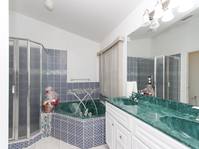 bathroom with tile patterned flooring, vanity, and shower with separate bathtub