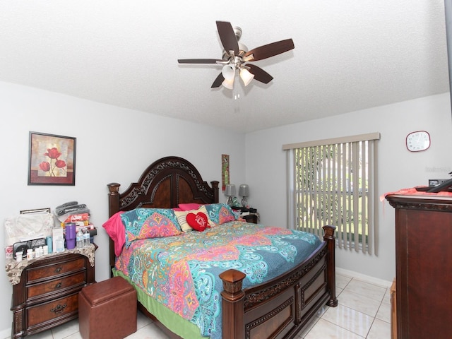 tiled bedroom featuring a textured ceiling and ceiling fan