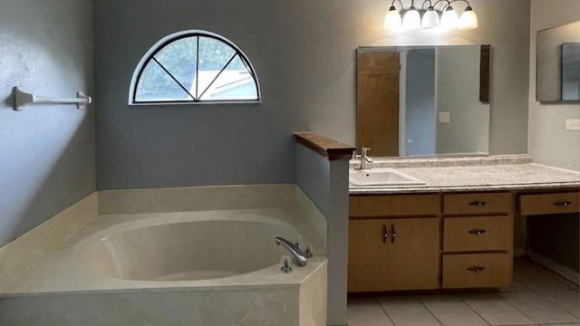 bathroom featuring tile patterned floors, vanity, and a bath