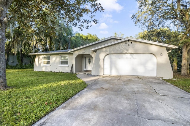 single story home with a garage and a front lawn