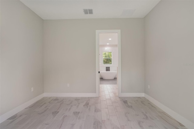 empty room with light hardwood / wood-style flooring