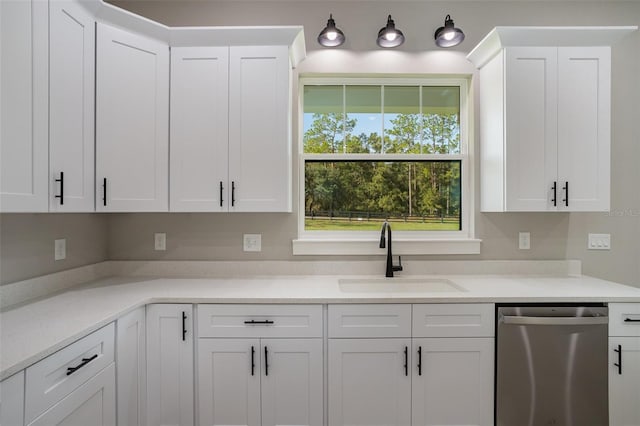 kitchen with white cabinets, dishwasher, and sink