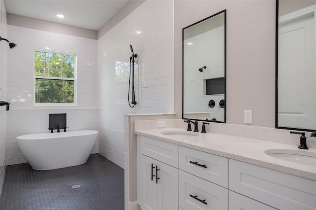 bathroom with tile patterned floors, vanity, shower with separate bathtub, and tile walls