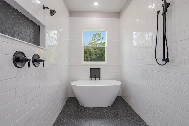 bathroom with tile patterned floors, tile walls, and plus walk in shower