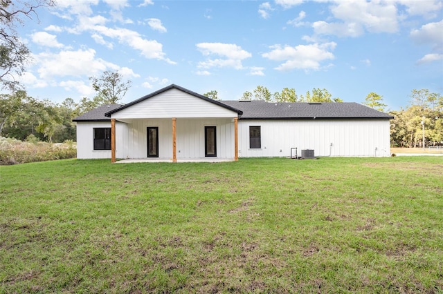 back of property with a lawn, central AC, and a patio