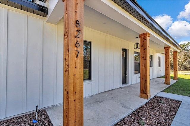 view of exterior entry with board and batten siding