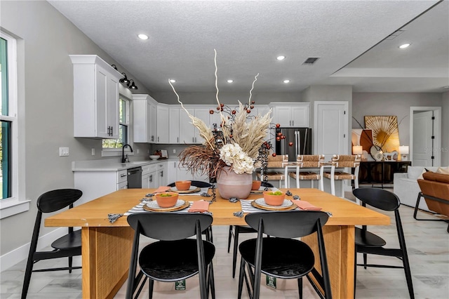 dining space with recessed lighting, visible vents, and a textured ceiling