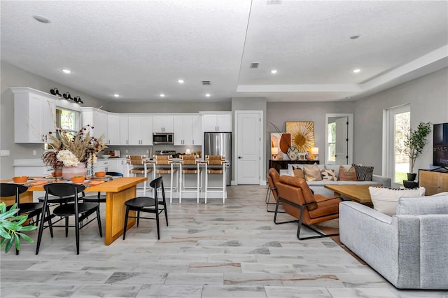 dining area featuring a textured ceiling, visible vents, and recessed lighting