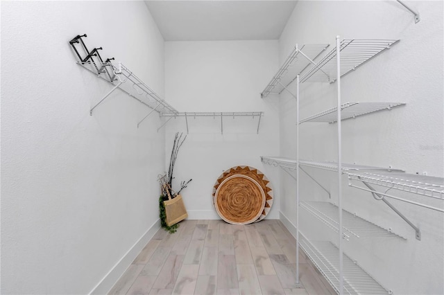 spacious closet featuring wood finished floors