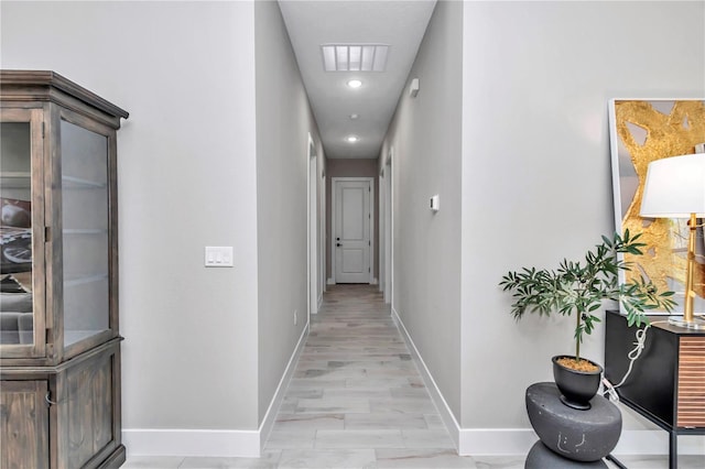 corridor featuring visible vents and baseboards