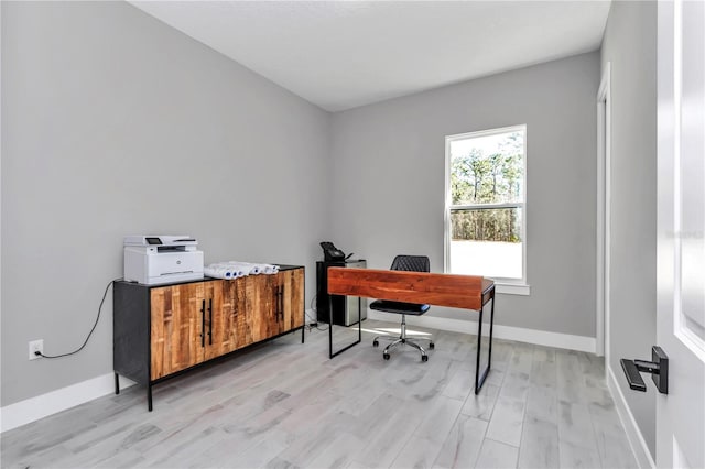 office area with light wood finished floors and baseboards