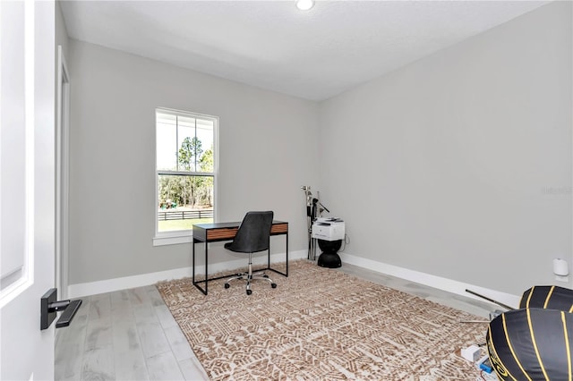 office area with baseboards and wood finished floors