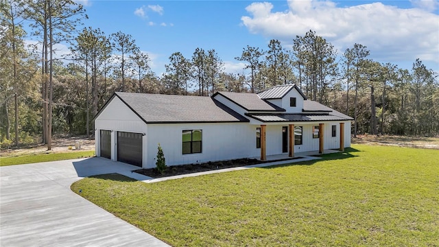 modern inspired farmhouse with covered porch, concrete driveway, a standing seam roof, metal roof, and a garage