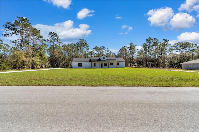 view of front of property with a front lawn and solar panels