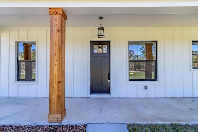 view of exterior entry with board and batten siding