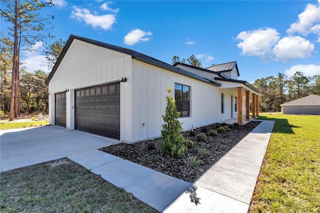 view of home's exterior with a garage, a standing seam roof, metal roof, and a yard