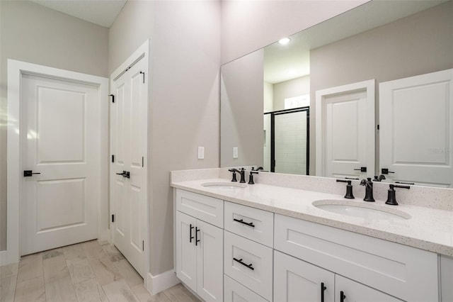 bathroom featuring hardwood / wood-style floors, vanity, and walk in shower