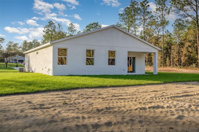 rear view of house featuring a lawn